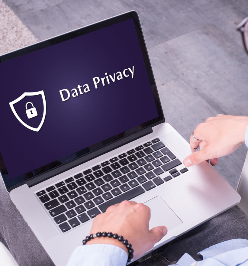 Laptop on someone knees showing a data privacy message