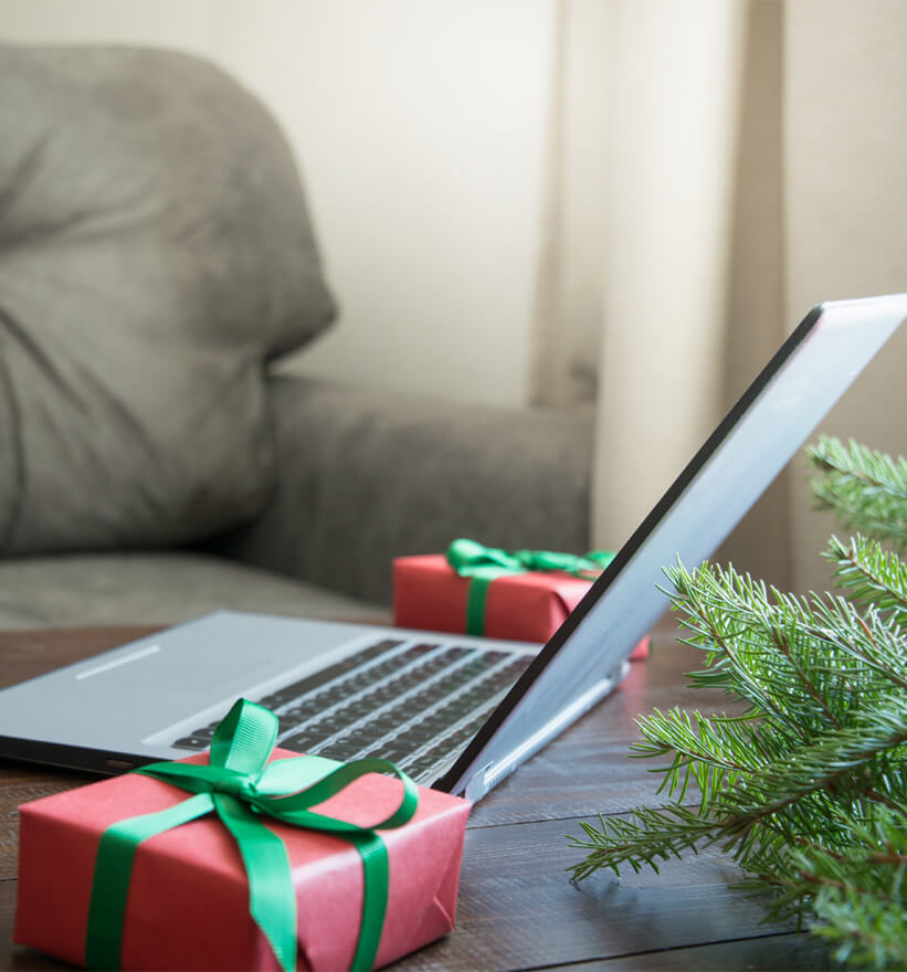 Laptop next to presents