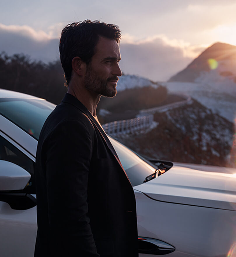 Man in front of a Mazda car